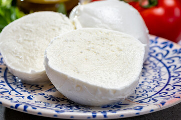 Fresh handmade soft Italian cheese from Campania, white balls of buffalo mozzarella cheese made from cow milk ready to eat