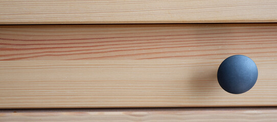 The black metal handle of the drawer. Stylish interior. Minimalism. Beautiful furniture