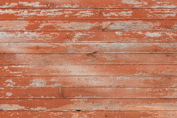 Background of old wooden board with cracked red paint