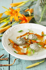 Chinese soup with dry daylily flowers (golden needles) and meatballs. daylily buds, edible flowers, foraging. daylily recipe. Asian cuisine