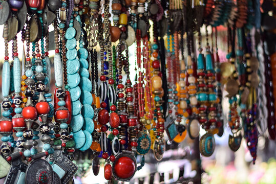 Traditional Indian beaded Necklace made of colored stones hanging in street market of India. These traditional ornamental items are very popular in India