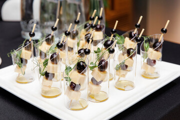 Set of canapes of cheese, olive and honey stand on the buffet table