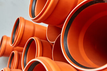 Orange plastic pipes lie in rows