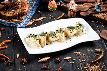 Slapjack rolls with salmon filling black caviar