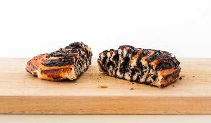 A Hungarian pastry called cocoa roll (kakós csiga) on a wooden cutting board.
