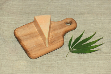 sliced cheese and green hemp leaf