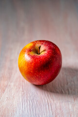 apple on a wooden pink background