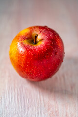 apple on a wooden pink background