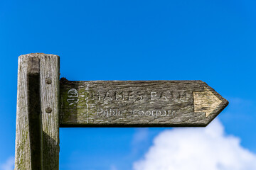 Wooden signpost showing the direction on the Thames Path
