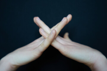 Isolated woman hand closeup making gestures on black background