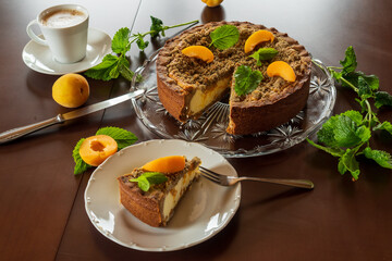 Cheesecake with fresh apricot for dessert - healthy organic summer berry dessert cheesecake and coffee, copy space, top view. Homemade cheese cake.