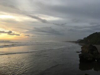 Golden Sunset in a tropical beach With sand, Horse and rock