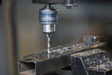 Industrial drilling machine drills a hole in the metal. Metal processing machines.