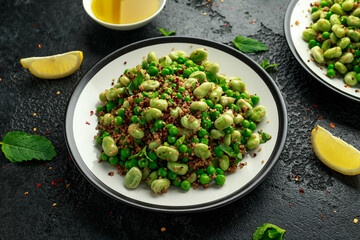 Vegan Green broad beans and quinoa salad with sweet peas and mint. Healthy food.