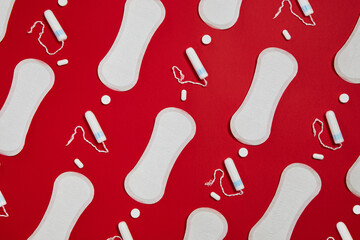 white sanitary cotton pads and tampons isolated on red background. Feminine hygiene products