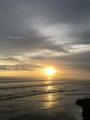 Golden Sunset in a tropical beach With sand, Horse and rock