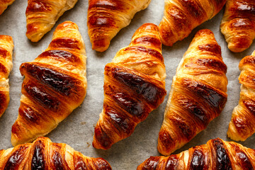 Freshly baked croissants with butter. background, texture