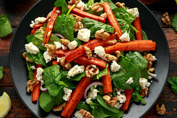 Roasted carrot salad with feta cheese, walnut and spinach. healthy food