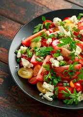 Tomato salad with feta cheese, spring onion and parsley. Healthy summer food