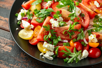 Tomato salad with feta cheese, spring onion and parsley. Healthy summer food