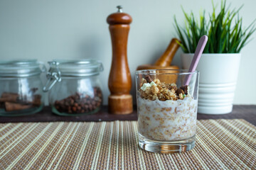 Useful muesli with nuts in a glass on the table. Healthy lifestyle