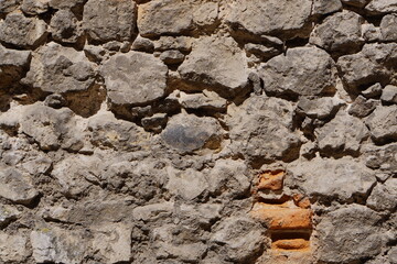Stone wall, large gray stones, civil and industrial construction.