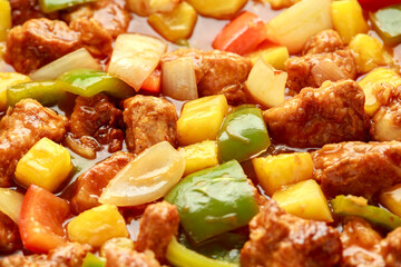 Pineapple and Chicken in sweet and sour sauce with bell pepper, rice and spring onion in pan