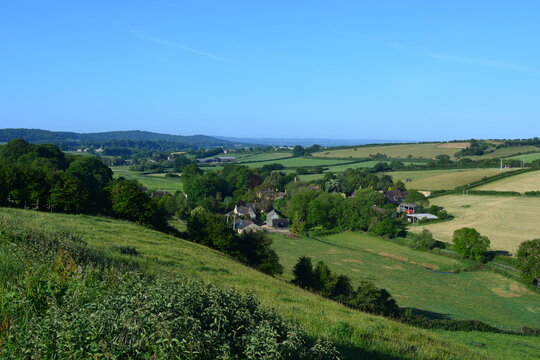 View to Oborne from Donkey Lane track in the summer, over farm fields and village to distant horizon. Dorset, England, UK © Josie Elias
