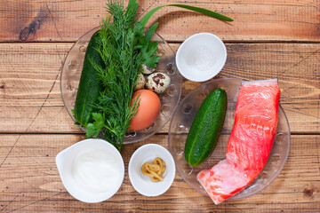 Step-by-step preparation of salad with salted salmon, fresh cucumbers and herbs, step 1 -...