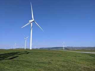 wind turbines in a wind farm with a mountain landscape