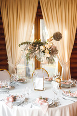 Festive table setting with empty wine glasses and fresh flowers