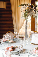 Wedding table setting with empty wine glasses and fresh flowers