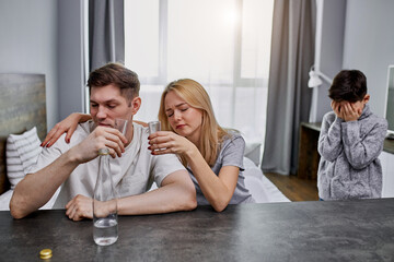 alcoholics parents do not care for the child, caucasian family suffer from alcohol addiction. desperate little child cry, ask for help, needs some love and affection