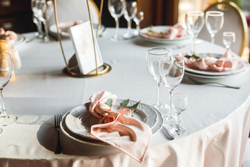 Close up festive table setting with empty wine glasses and white plate