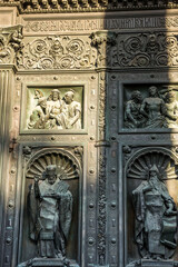 Religious statue on the bronze door of Saint Isaac’s Cathedral (or Isaakievskiy Sobor), a monuments of Russian architecture,near Nevsky Avenue and the Hermitage Museum in Saint Petersburg, Russia.