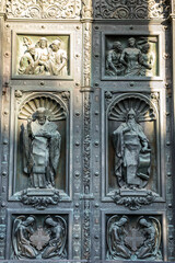 Religious statue on the bronze door of Saint Isaac’s Cathedral (or Isaakievskiy Sobor), a monuments of Russian architecture,near Nevsky Avenue and the Hermitage Museum in Saint Petersburg, Russia.