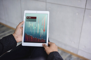 Financial or Economy Crisis Concept. Business Leader. Stock Marketing Graph is going Crash and Down. Professional Businessman seeing Low Profit Graph on Tablet