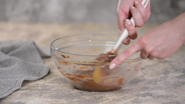 Mixing ingredients to make chocolate choux pastry at home.