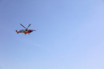 Naklejka na ściany i meble Coastguard Helicopter with blue sky, UK