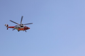 Fototapeta na wymiar Coastguard Helicopter with blue sky, UK