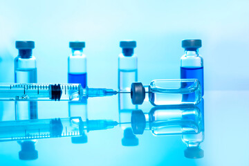 Close-up medical syringe with a vaccine. Vaccination and healtcare concept.