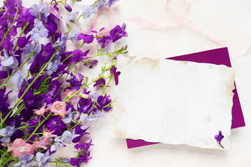 greeting card mockup. bouquet of violet flowers and space for text. congratulation. invitation