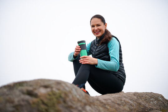 Heppy Beautiful Woman Resting after Running Outdoor. Workout at Autumn Evening. Sport and Healthy Active Lifesyle.