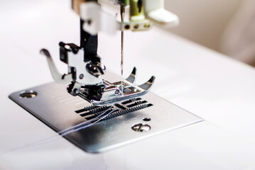 Sewing machine. Handmade work. Textile factory. Sewing machine sews fabric.