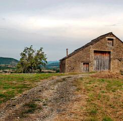 Fototapeta na wymiar Village with stone houses in the Pyrenees mountains in a cloudy day