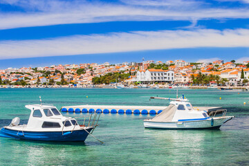 Croatia, waterfront view of the town of Novalja on the island of Pag, boats in marina and turquoise sea in foreground, famous tourist destination.