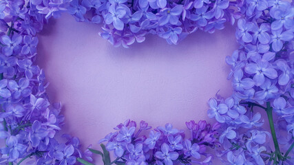 Lilac flowers on purple textured background. Spring flowers. Top view, flat lay. Spring concept with copy space.