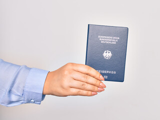 Hand of caucasian young woman holding Germany German passport document over isolated white background