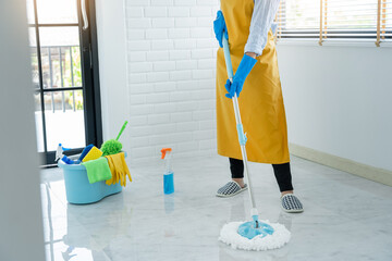 Young housekeeper or washing cleaning floor at mop in protective gloves, Housework Cleaning service.