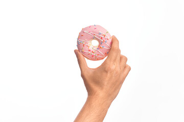 Hand of caucasian young man holding delicious sweet chocolate doughnut over isolated white background